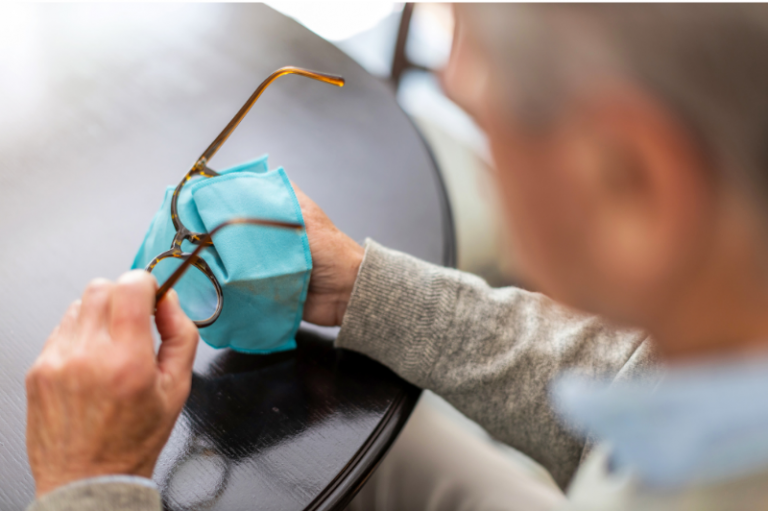 Senior Man Holding Eyeglasses